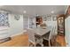 Bright dining room with hardwood floors, elegant decor, and a table for Gathering gatherings at 5855 Willis Ln, Cumming, GA 30040
