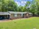 Front exterior of home featuring a covered parking area and front porch at 5855 Willis Ln, Cumming, GA 30040