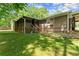 Charming home exterior featuring screened porch, a well-maintained lawn, ladder and ample space for outdoor activities at 5855 Willis Ln, Cumming, GA 30040
