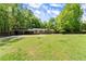 Charming home exterior with a long driveway and a well-maintained lawn at 5855 Willis Ln, Cumming, GA 30040