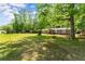 Ranch style home with large front yard and mature trees at 5855 Willis Ln, Cumming, GA 30040