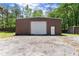 This large metal outbuilding has plenty of space for storage and a garage door at 5855 Willis Ln, Cumming, GA 30040
