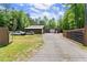 An outdoor driveway leading to multiple outbuildings and storage areas at 5855 Willis Ln, Cumming, GA 30040