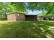 The back of this home has a large back yard, screened-in porch, and carport at 5855 Willis Ln, Cumming, GA 30040