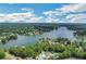 Breathtaking aerial view of a waterfront community with lush greenery and stunning lake views under a blue sky at 1215 Wynridge Xing, Alpharetta, GA 30005