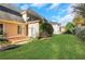 A spacious backyard with green grass, a brick patio, and mature trees at 1215 Wynridge Xing, Alpharetta, GA 30005