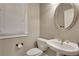 A classic bathroom showcasing a pedestal sink with vintage-style fixtures and natural light at 1215 Wynridge Xing, Alpharetta, GA 30005