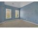 Cozy bedroom with blue walls, star decorations and two large windows providing ample natural light at 1215 Wynridge Xing, Alpharetta, GA 30005