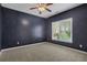 A cozy bedroom featuring plush carpeting, a ceiling fan, and a sunlit window at 1215 Wynridge Xing, Alpharetta, GA 30005