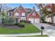 Beautiful brick home with a well-manicured lawn and two-car garage at 1215 Wynridge Xing, Alpharetta, GA 30005