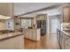 Open kitchen featuring hardwood floors, an island, stainless steel appliances, and a breakfast nook at 1215 Wynridge Xing, Alpharetta, GA 30005