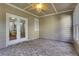 A covered patio with brick flooring, exposed to an open green space at 1215 Wynridge Xing, Alpharetta, GA 30005