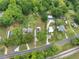 Aerial view of a property with lush trees, green grass, and multiple dwellings near a train track at 1236 Stone Mountain Lithonia Rd, Lithonia, GA 30058