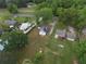 Aerial view of several houses with green lawns and trees near a road and train track at 1236 Stone Mountain Lithonia Rd, Lithonia, GA 30058