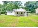View of the home's backyard featuring green grass and the back of the house at 1236 Stone Mountain Lithonia Rd, Lithonia, GA 30058