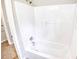 Bright white bathroom with shower head over a clean, white tub at 1236 Stone Mountain Lithonia Rd, Lithonia, GA 30058