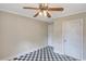 Bedroom showcasing classic checkerboard flooring and a stylish ceiling fan with integrated lighting at 1236 Stone Mountain Lithonia Rd, Lithonia, GA 30058