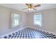 Bedroom with checkerboard flooring features a ceiling fan, two windows, and neutral colored walls at 1236 Stone Mountain Lithonia Rd, Lithonia, GA 30058