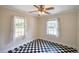 Small bedroom with black and white tiled floor, natural light from two windows, and a ceiling fan at 1236 Stone Mountain Lithonia Rd, Lithonia, GA 30058