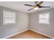 Bedroom filled with natural light from two windows and showcasing a contemporary ceiling fan at 1236 Stone Mountain Lithonia Rd, Lithonia, GA 30058