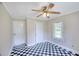 Bedroom features black and white checkerboard flooring, ceiling fan, and window allowing natural light at 1236 Stone Mountain Lithonia Rd, Lithonia, GA 30058