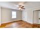 Bright bedroom featuring gleaming hardwood floors, neutral walls, and a well-lit ceiling fan at 1236 Stone Mountain Lithonia Rd, Lithonia, GA 30058