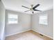 Neutral bedroom with a ceiling fan and two windows at 1236 Stone Mountain Lithonia Rd, Lithonia, GA 30058