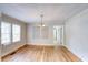 Dining area with hardwood floors, natural light from two windows, and access to another room at 1236 Stone Mountain Lithonia Rd, Lithonia, GA 30058