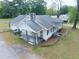 Home featuring a covered porch, stone accents and mature landscaping at 1236 Stone Mountain Lithonia Rd, Lithonia, GA 30058