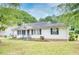 Attractive single-Gathering home featuring classic design, manicured lawn, and a welcoming front porch at 1236 Stone Mountain Lithonia Rd, Lithonia, GA 30058