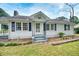 Charming home featuring a white exterior, inviting front porch, and a well-maintained front yard at 1236 Stone Mountain Lithonia Rd, Lithonia, GA 30058