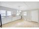 Bright kitchen features white cabinets, a window over the sink, and durable tile flooring at 1236 Stone Mountain Lithonia Rd, Lithonia, GA 30058