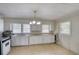 Kitchen featuring neutral linoleum floors, white cabinets, and natural light from two windows at 1236 Stone Mountain Lithonia Rd, Lithonia, GA 30058