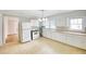 Eat-in kitchen area featuring white appliances, neutral countertops, and ample cabinet space at 1236 Stone Mountain Lithonia Rd, Lithonia, GA 30058