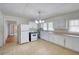 Spacious kitchen with white cabinets, linoleum flooring, and a view into the dining room at 1236 Stone Mountain Lithonia Rd, Lithonia, GA 30058