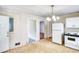 Kitchen with linoleum flooring, white appliances, and access to other rooms in the home at 1236 Stone Mountain Lithonia Rd, Lithonia, GA 30058