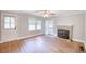 Living room featuring hardwood floors, natural light, and a fireplace with stone surround at 1236 Stone Mountain Lithonia Rd, Lithonia, GA 30058