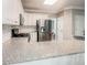 Spacious kitchen showcasing granite countertops, stainless steel appliances, white cabinetry, and subway tile backsplash at 1485 Oglethorpe Run Ln, Suwanee, GA 30024