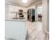 Well-lit kitchen featuring an island sink, granite countertops, stainless steel appliances, and sleek white cabinets at 1485 Oglethorpe Run Ln, Suwanee, GA 30024