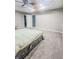 Spacious main bedroom with a tray ceiling, carpeted floor, and neutral decor; a serene retreat at 1485 Oglethorpe Run Ln, Suwanee, GA 30024