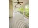 Covered porch with gray wood floors and a railing at 1485 Oglethorpe Run Ln, Suwanee, GA 30024