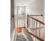 Bright staircase with wooden handrails and a chandelier hanging above the front door, offering a grand entrance at 1485 Oglethorpe Run Ln, Suwanee, GA 30024