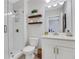Well lit bathroom offers a tiled shower, modern fixtures, and decorative shelves at 160 Cricket Ln, Alpharetta, GA 30009