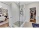 Bright bathroom featuring frameless glass shower, tile flooring, and walk-in closet at 160 Cricket Ln, Alpharetta, GA 30009