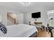 Bedroom features modern lighting, mounted tv, desk, and ensuite bathroom at 160 Cricket Ln, Alpharetta, GA 30009
