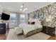Luxurious bedroom featuring a stylish accent wall, modern lighting, and elegant furnishings at 160 Cricket Ln, Alpharetta, GA 30009