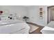 Well-lit bedroom boasts plush bedding, hardwood floors, and ample storage for comfortable and organized living at 160 Cricket Ln, Alpharetta, GA 30009