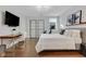 Bright bedroom features a mounted tv, desk, modern decor, and lots of natural light at 160 Cricket Ln, Alpharetta, GA 30009