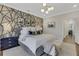 Bright and airy bedroom boasts modern decor, a stylish accent wall, and comfortable furnishings at 160 Cricket Ln, Alpharetta, GA 30009