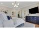 Relaxing bedroom features modern lighting, an en suite bathroom, and stylish furnishings at 160 Cricket Ln, Alpharetta, GA 30009
